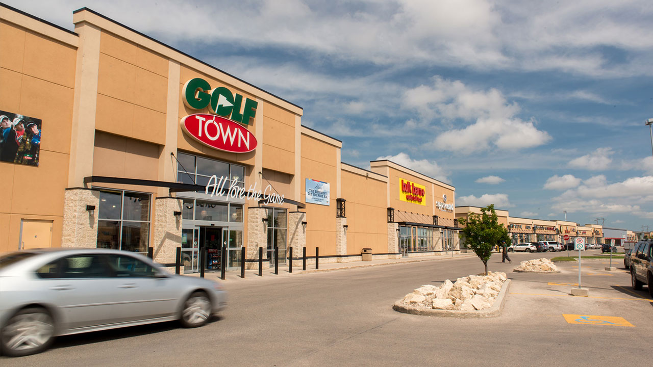Wide angle image of affordable sporting goods, bulk foods and other mixed retailers at a SmartCentres retail property in Winnipeg